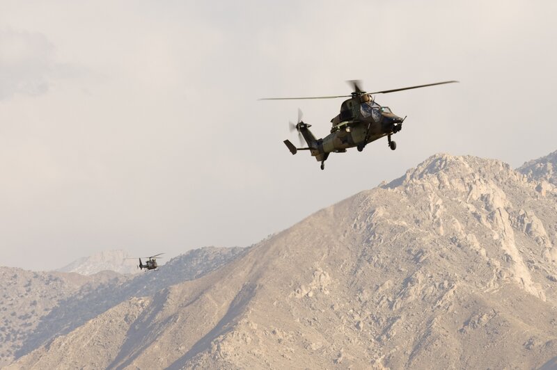 Military helicopters over mountains