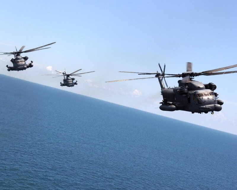 Military helicopters over the ocean
