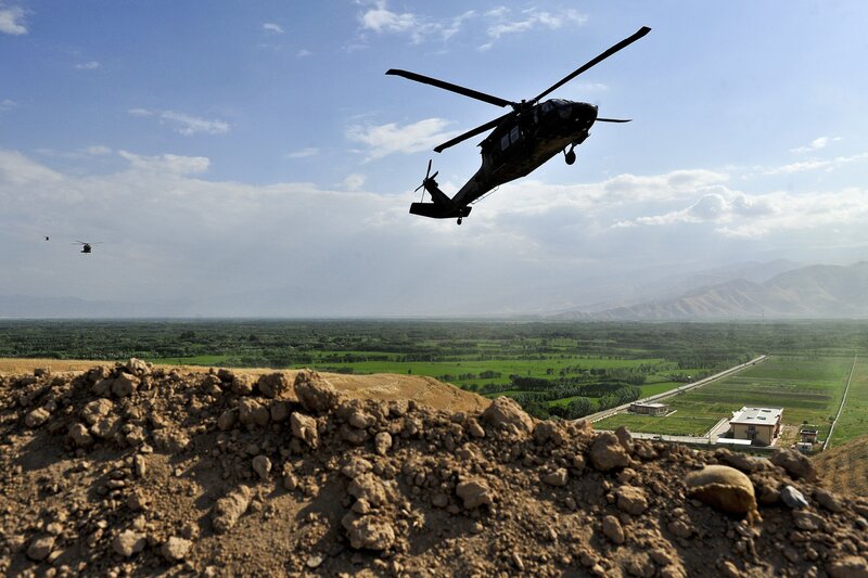 Military helicopters over valley