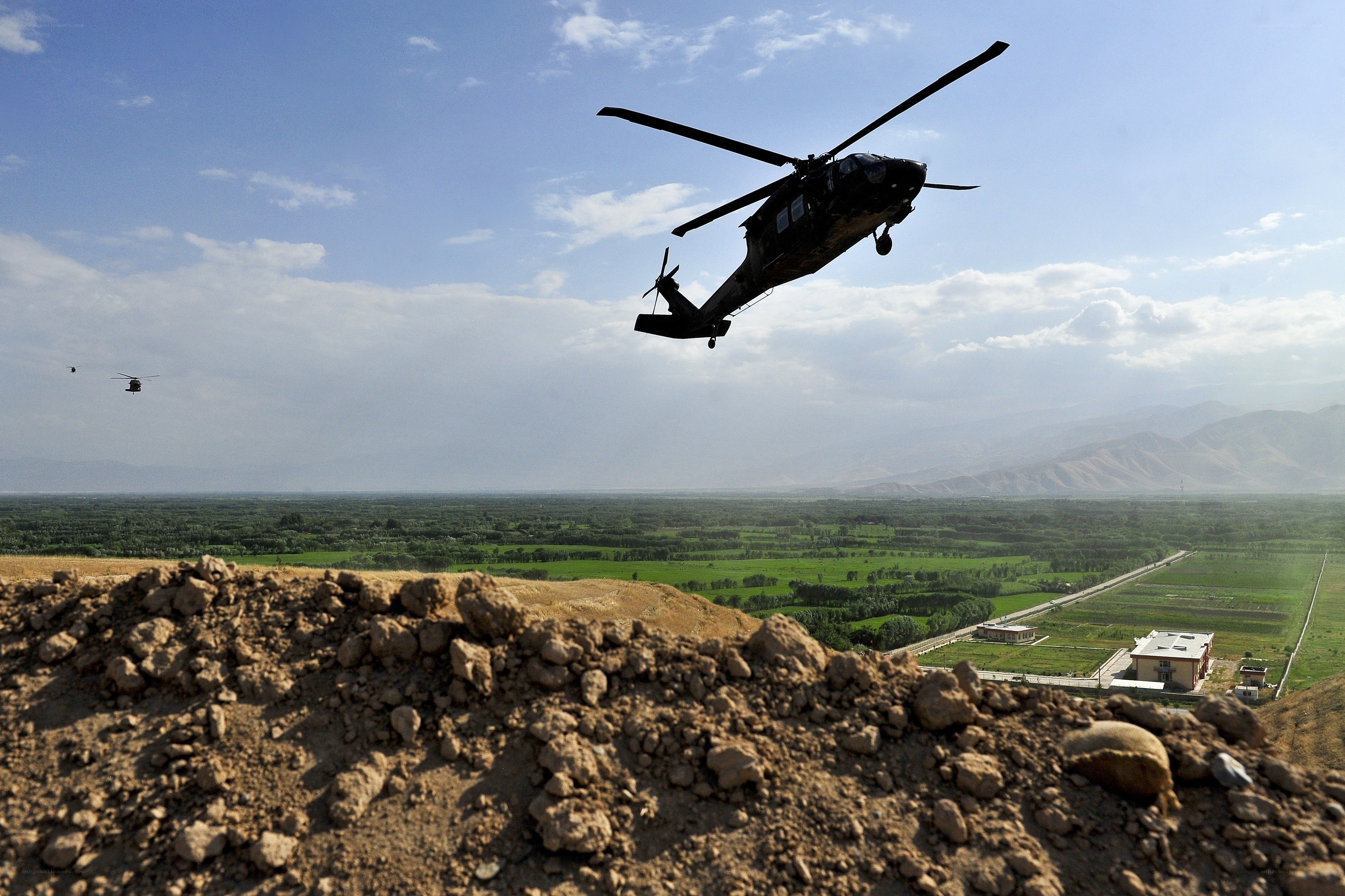 Military helicopters over valley