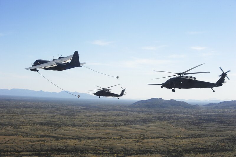 Military helicopters refueling in flight