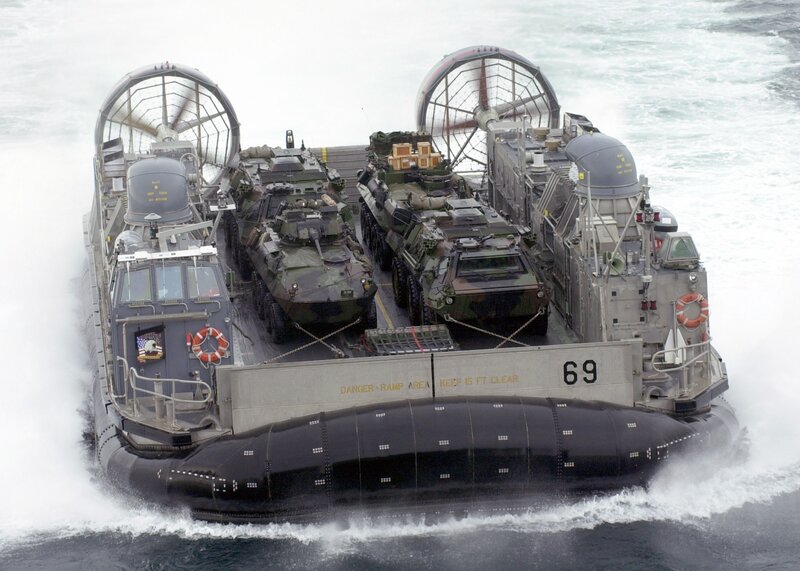 Military hovercraft carrying armored vehicles