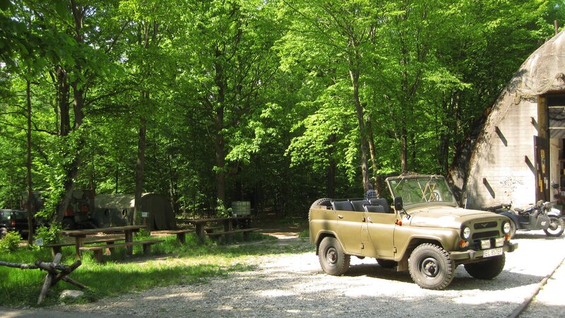 Military jeep in forest camp