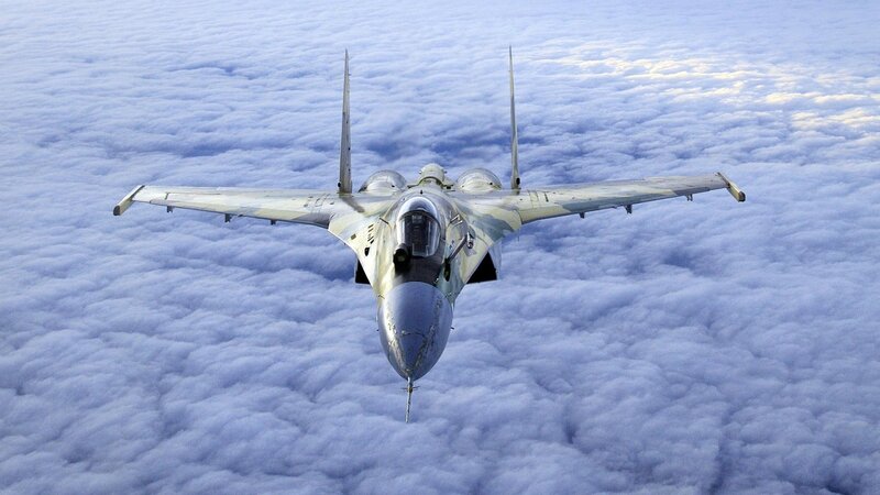 Military Jet Above Clouds — Blue, Serene