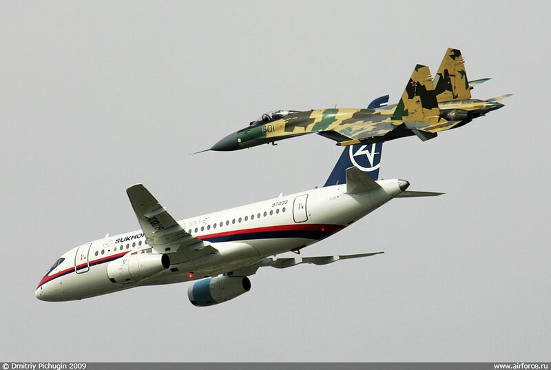 Military Jet Escorting Airliner