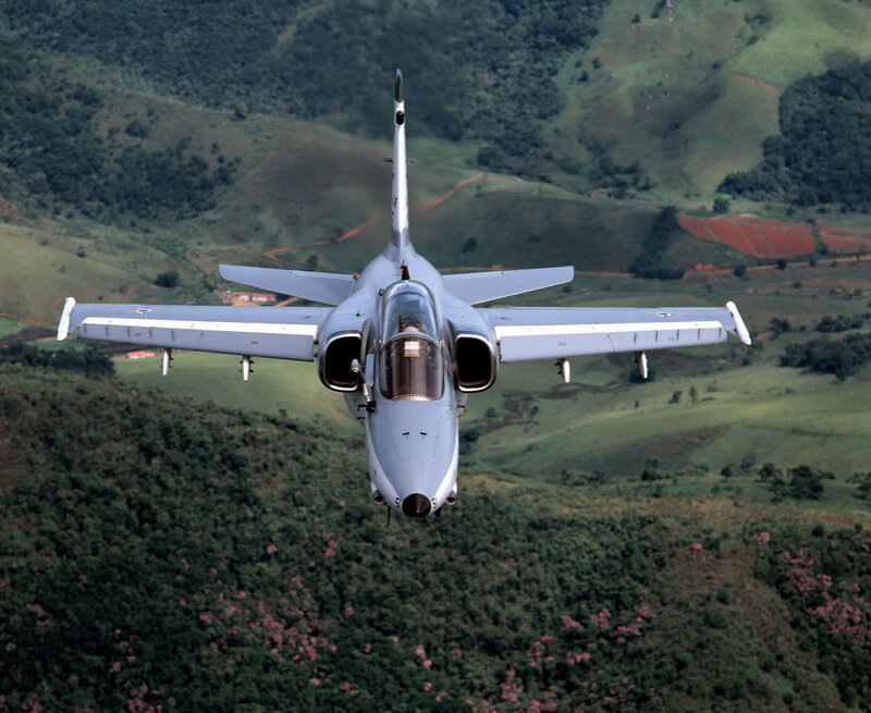 military jet flying over hills