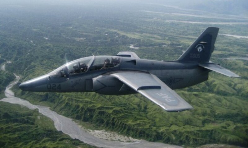 military jet flying over landscape