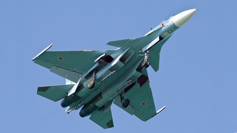 Military Jet in Flight — Blue