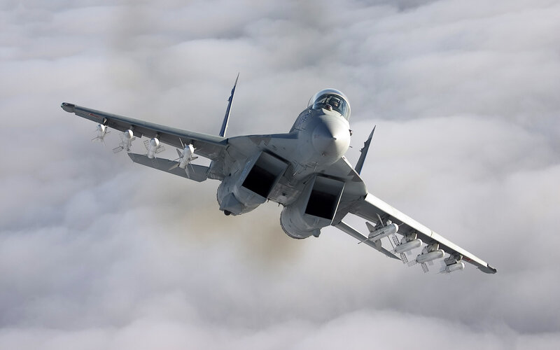 Military Jet in Flight — Gray, Dramatic, Photograph, Clouds, Missiles, Wings