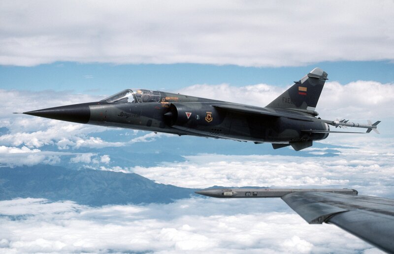 Military Jet in Flight — Gray, Dramatic, Photograph, Clouds, Mountains