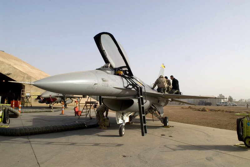 Military jet maintenance on tarmac