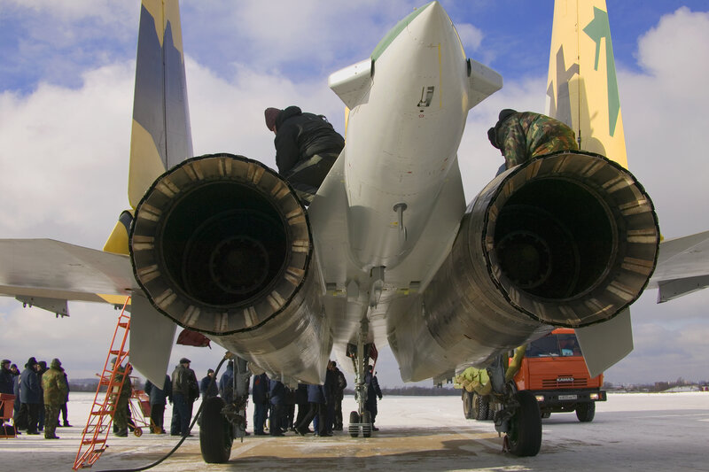 Military jet maintenance on tarmac