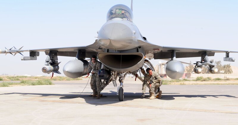 Military jet maintenance on tarmac