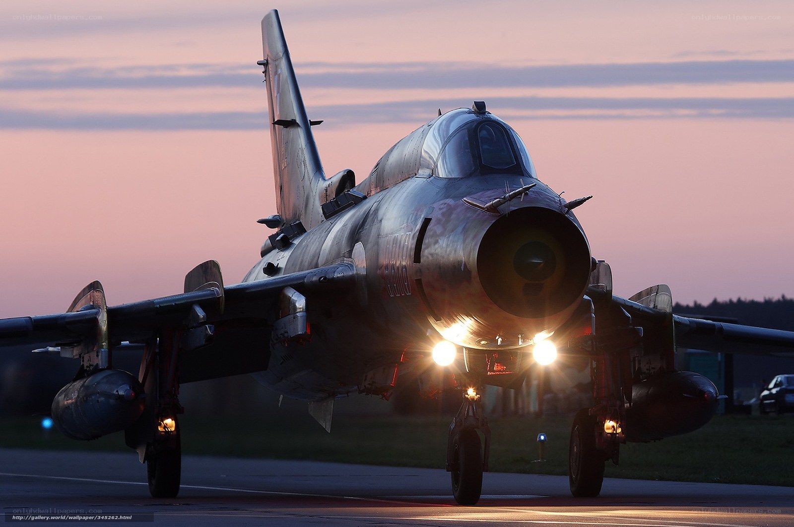 military jet on runway at dusk