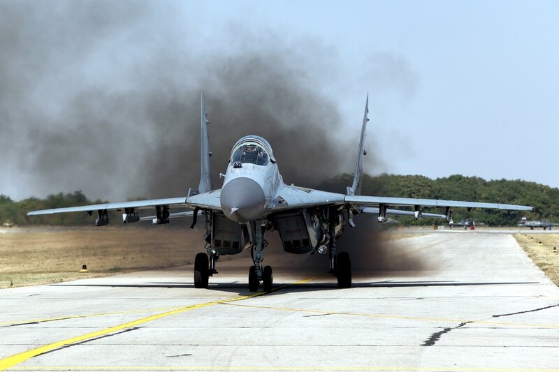 Military Jet on Runway — Gray, Dramatic