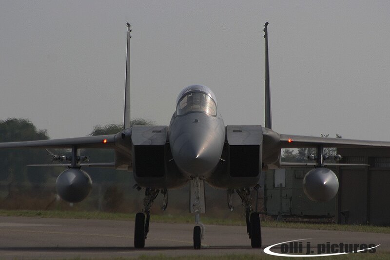 Military Jet on Runway — Gray, Neutral, Afternoon, Photograph, Trees, Building