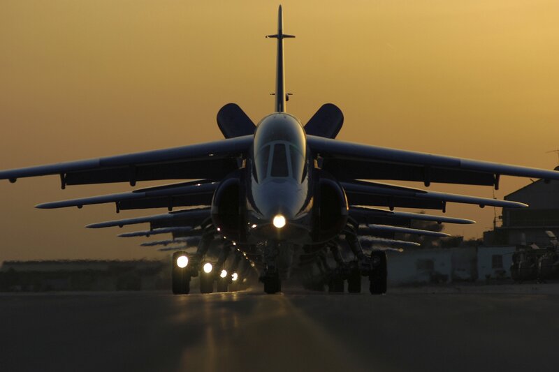 Military Jet on Runway — Orange