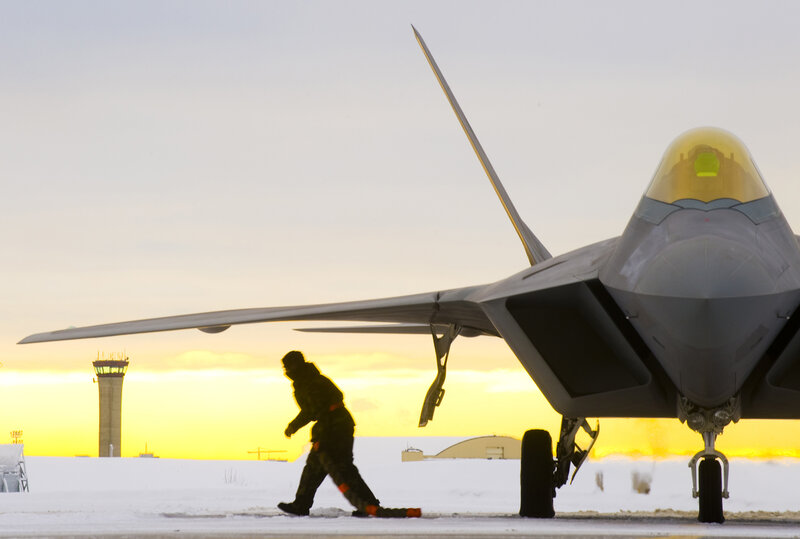 Military jet on snowy tarmac