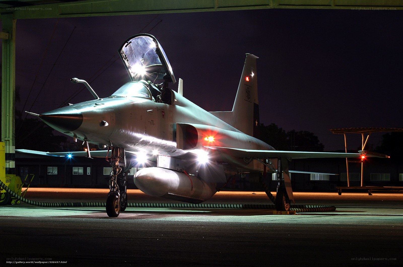 military jet on tarmac at night