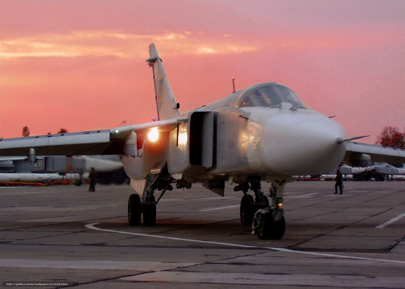 military jet on tarmac at sunset