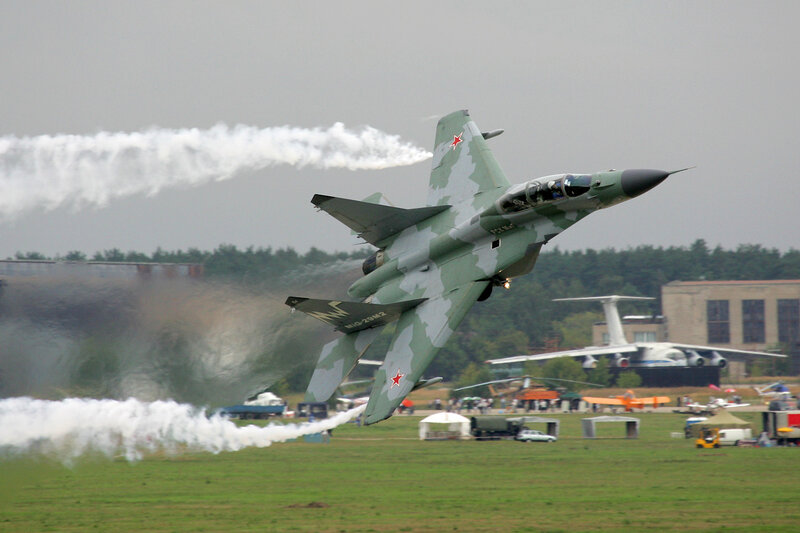 Military Jet Performing Aerobatics — Green