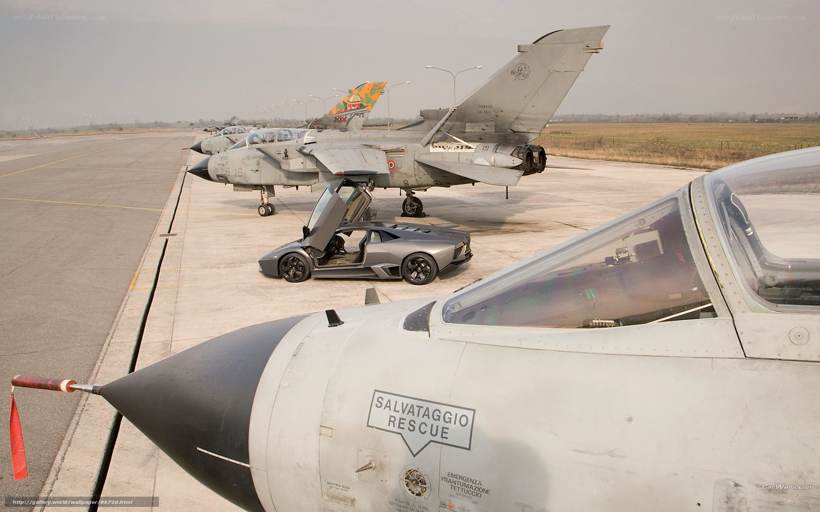 Military jets and supercar on tarmac