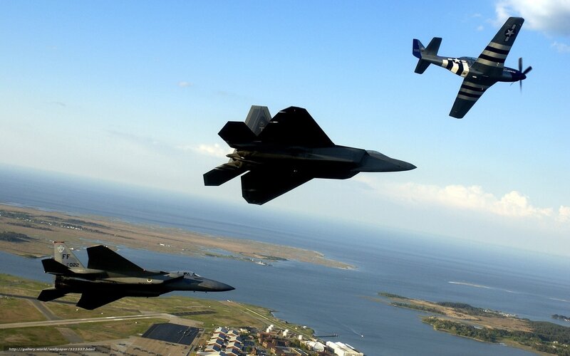 Military jets in formation over coast