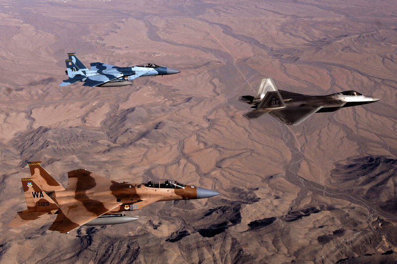 Military jets in formation over desert