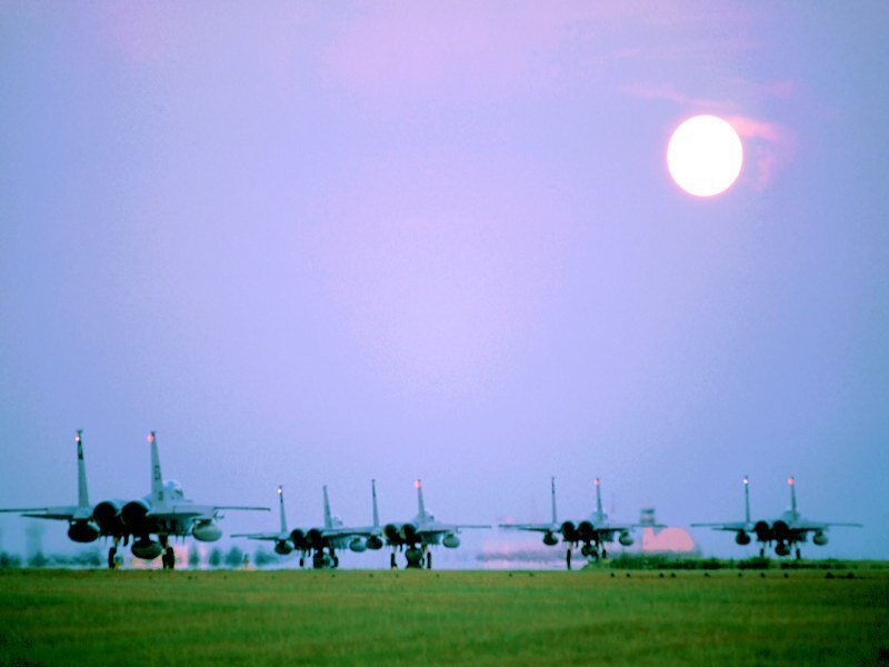Military jets on a runway at dusk