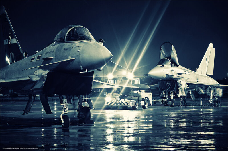 Military jets on tarmac at night