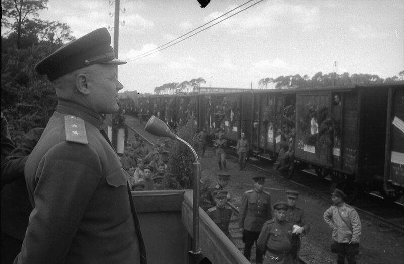 Military officer addressing troops at train station