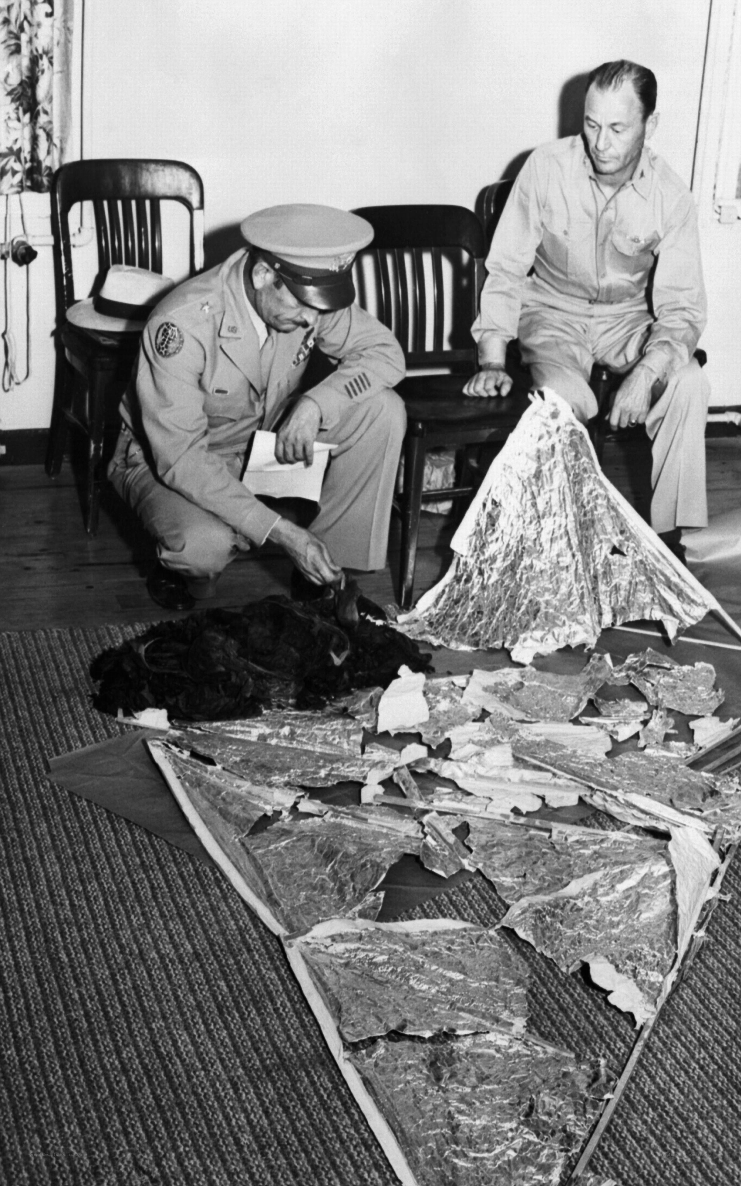 Military officials examine debris