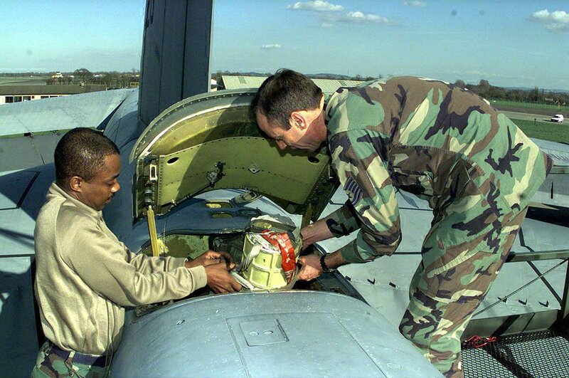 Military personnel loading aircraft