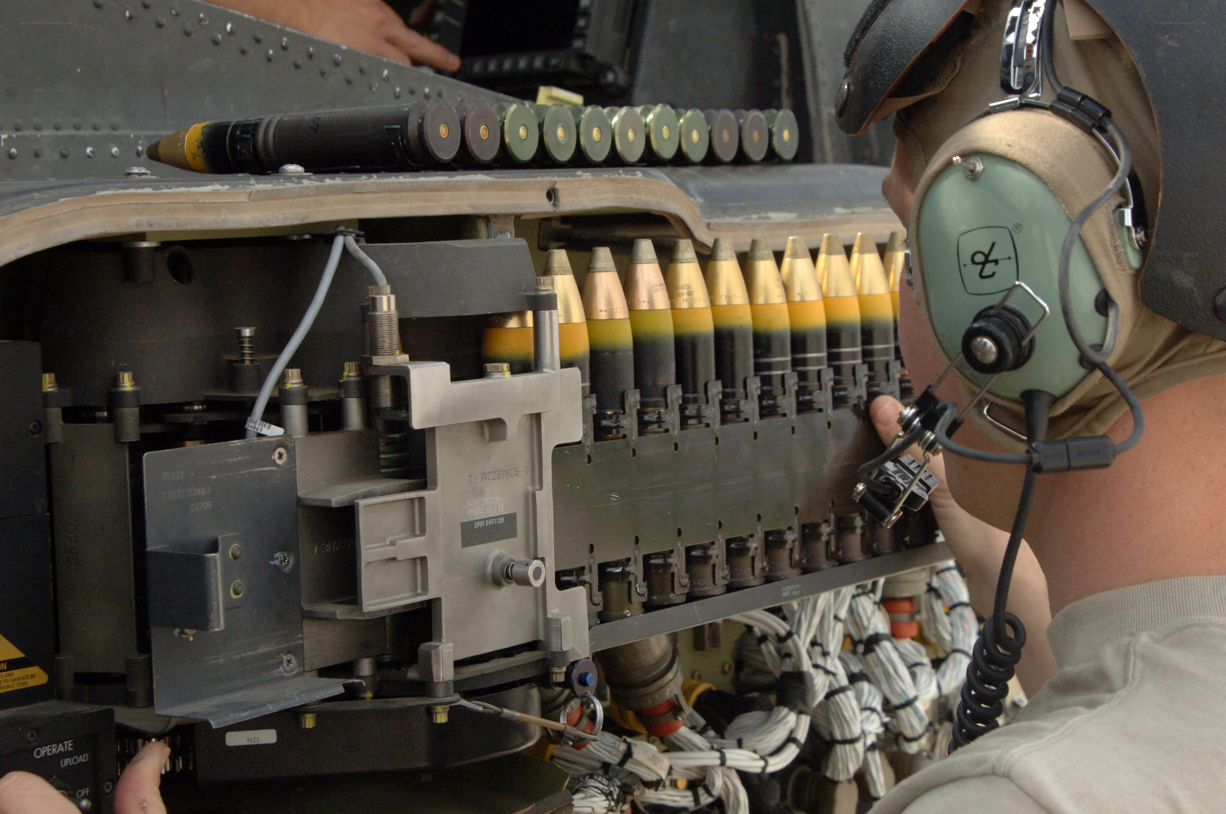 Military personnel loading ammunition