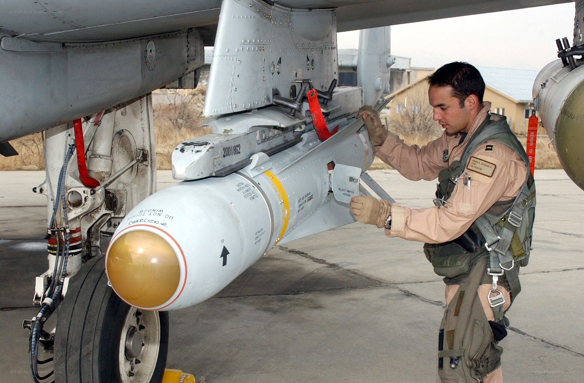 Military personnel loading missile