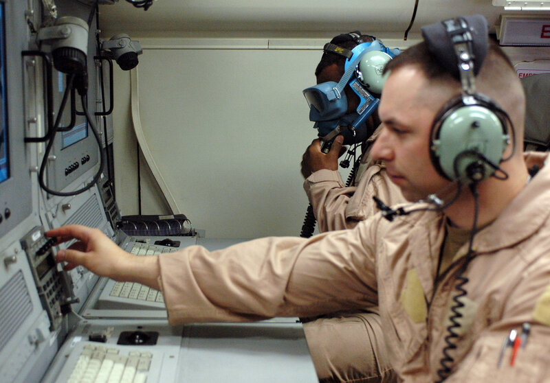 Military personnel operating controls