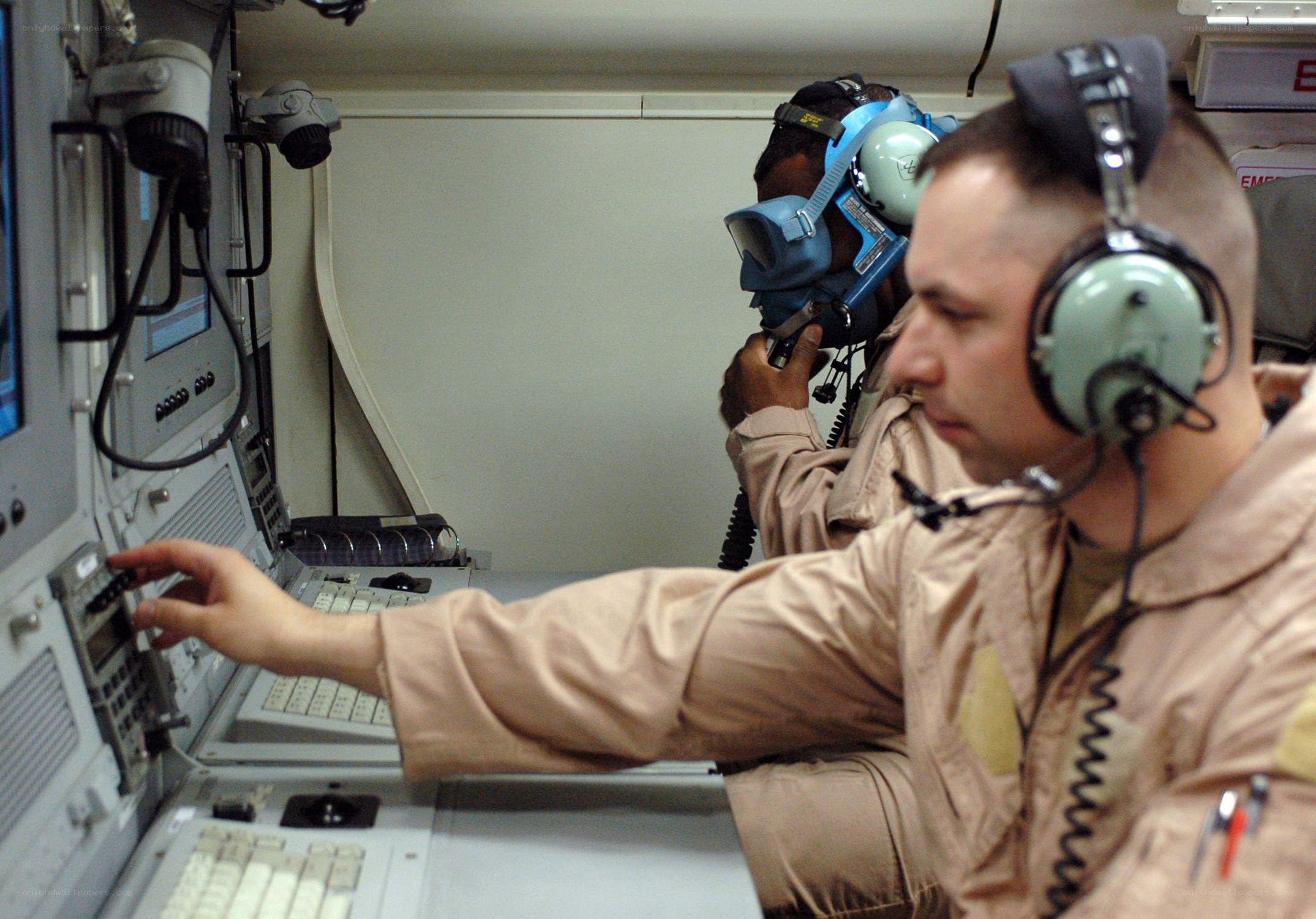 Military personnel operating controls