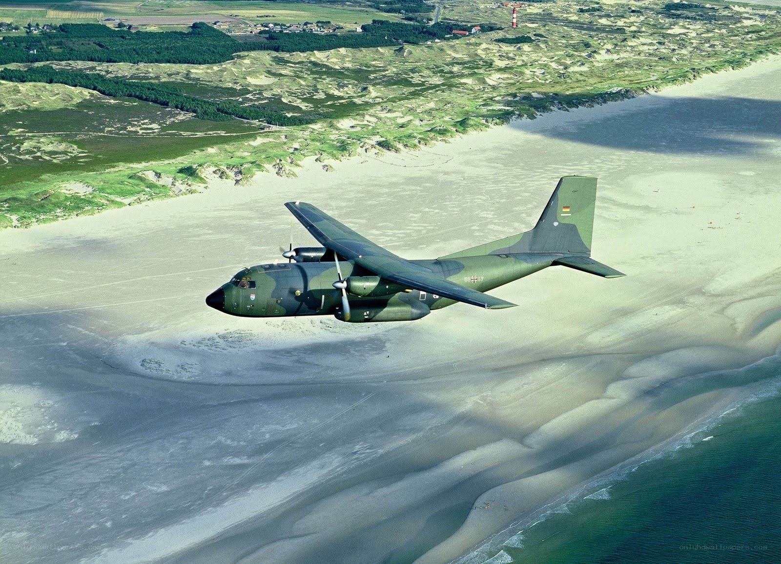 military plane over beach