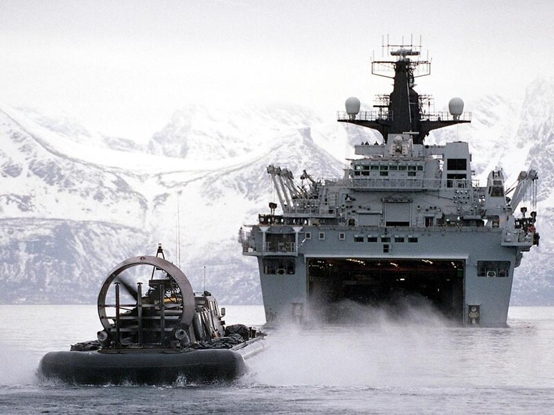 Military ship and hovercraft in snowy waters