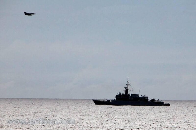 Military ship and jet over sea
