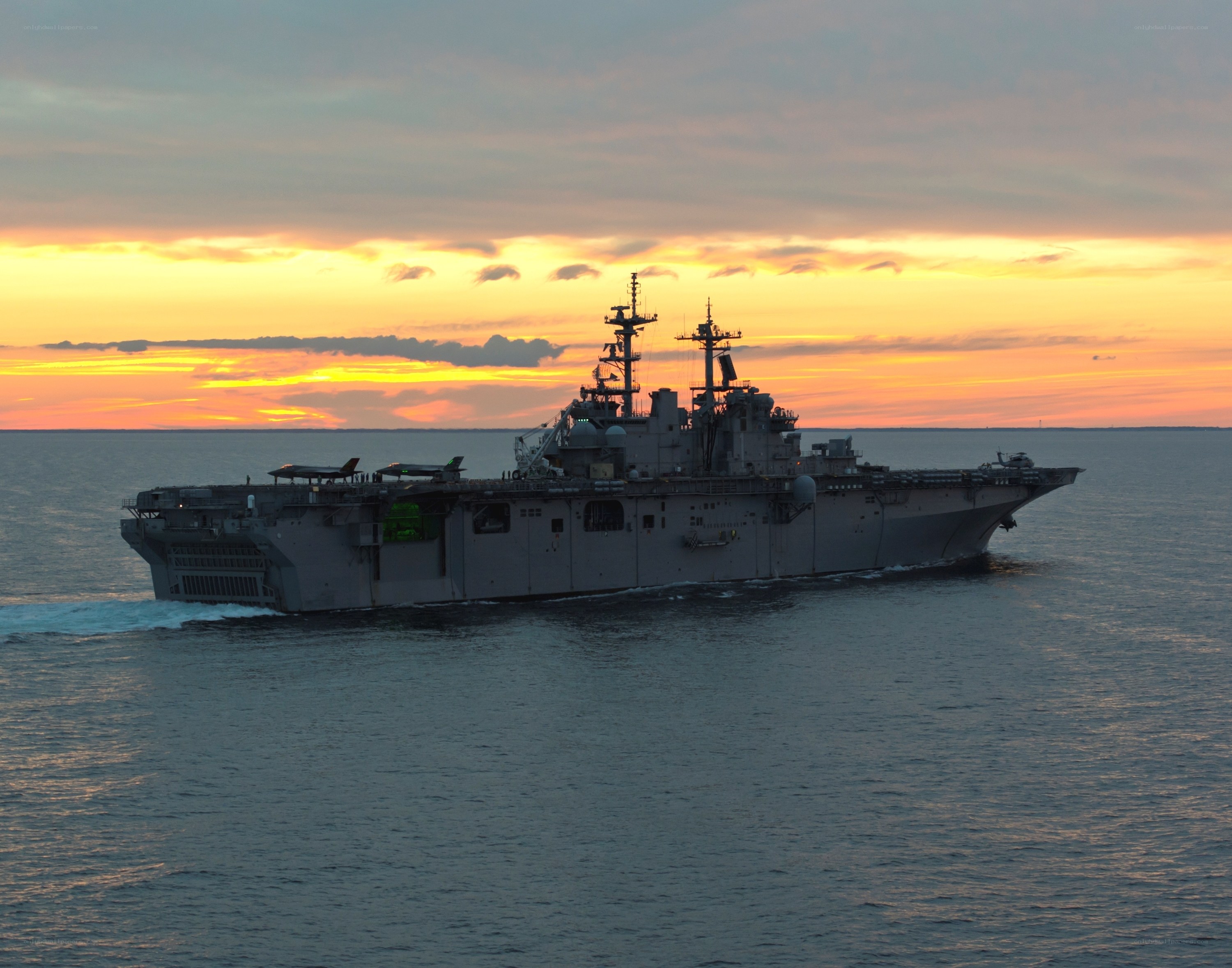 Military ship at sunset