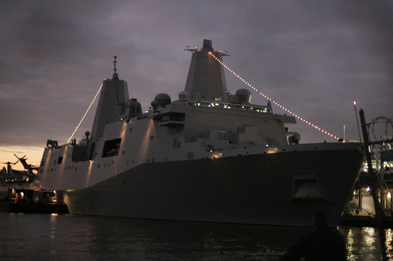 Military ship docked at dusk