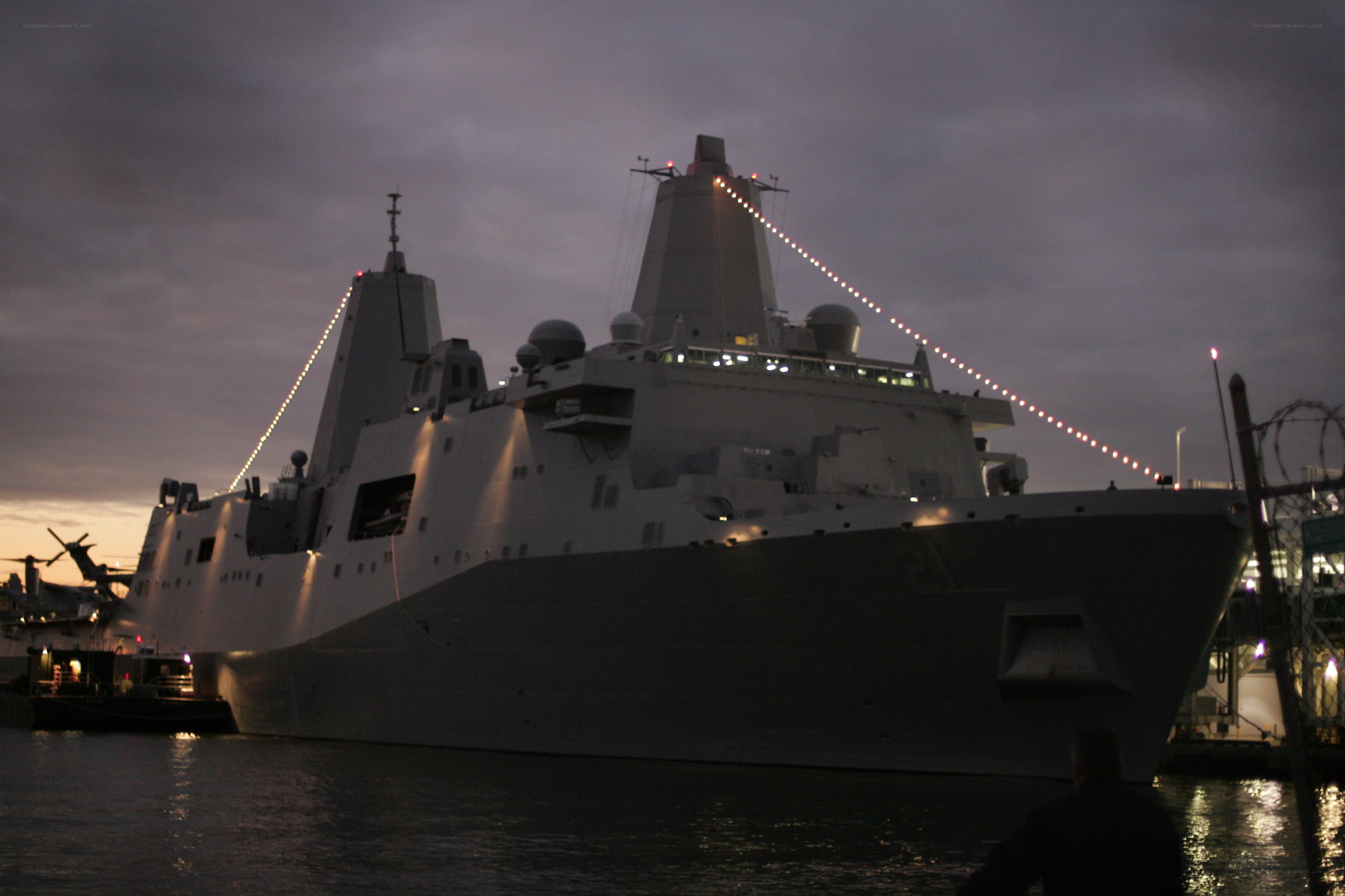 Military ship docked at dusk