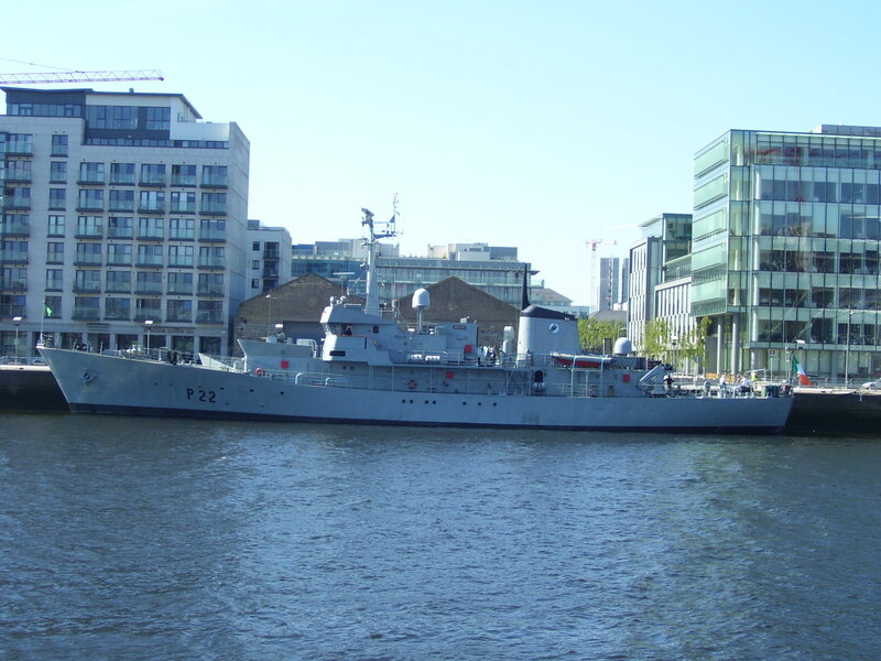 Military ship docked in city harbor