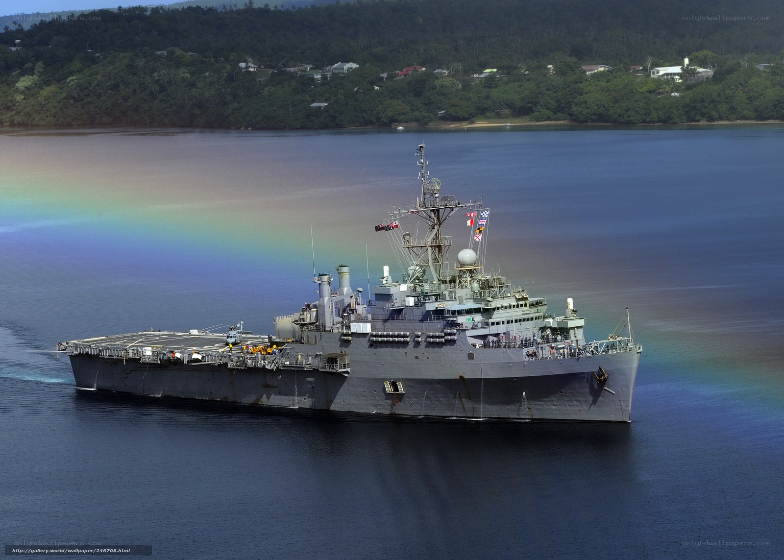 Military ship in harbor with rainbow