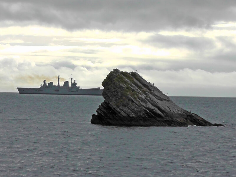 Military Ship Near Rock