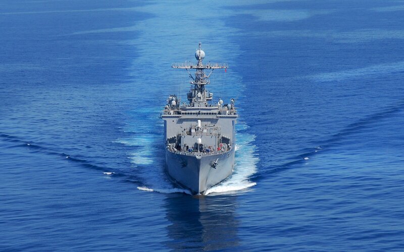 Military ship sailing on blue sea