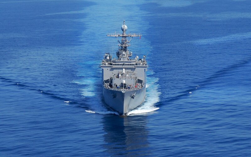 Military ship sailing on blue sea
