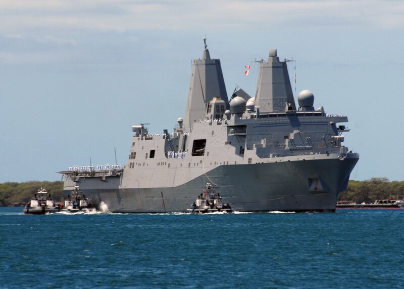 Military ship with tugboats