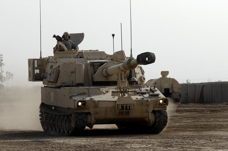 Military tank in desert terrain